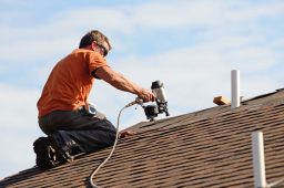 East Moline roofing contractor putting the asphalt roofing on a house.