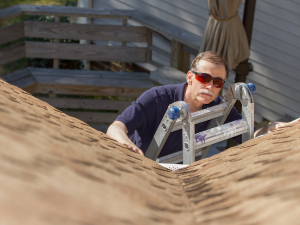Certified roofing contractor inspecting roof in Rock Island.