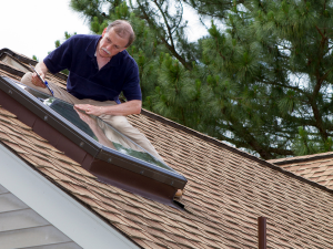 Professional roof inspector from East Moline roofing services evaluating storm damage.