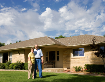 Happy Milan homeowners after a roof installation.